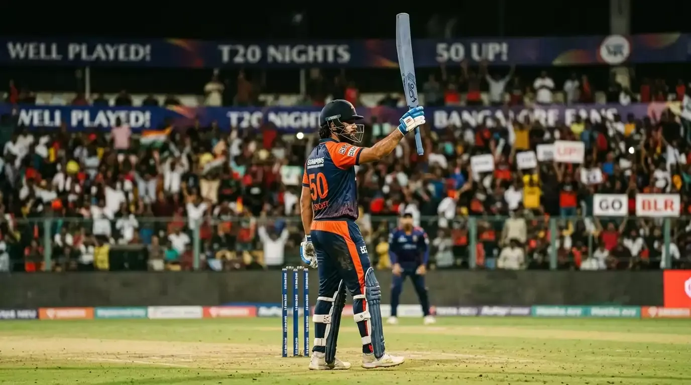 Cricket batter raising bat to celebrate a half-century during a T20 match