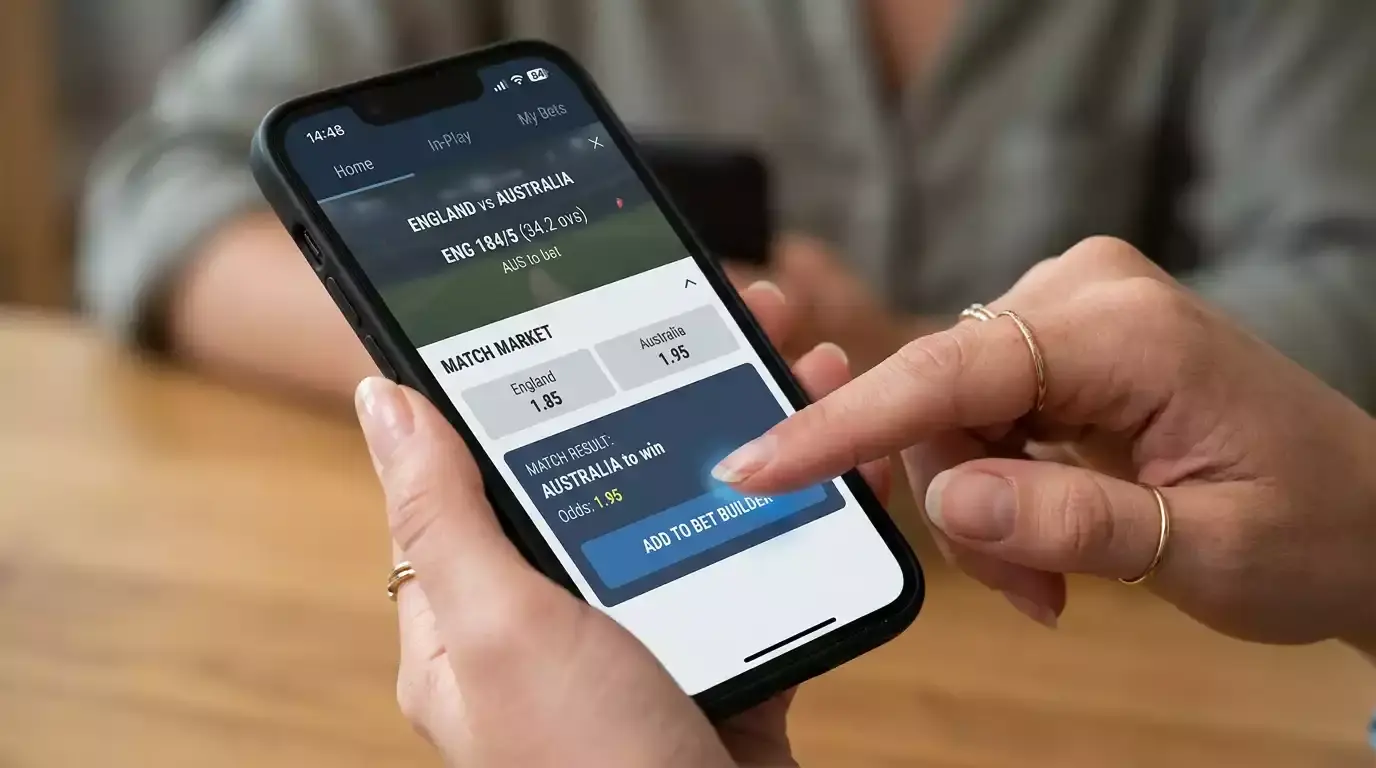 Hand selecting a cricket bet builder leg on a mobile sportsbook interface
